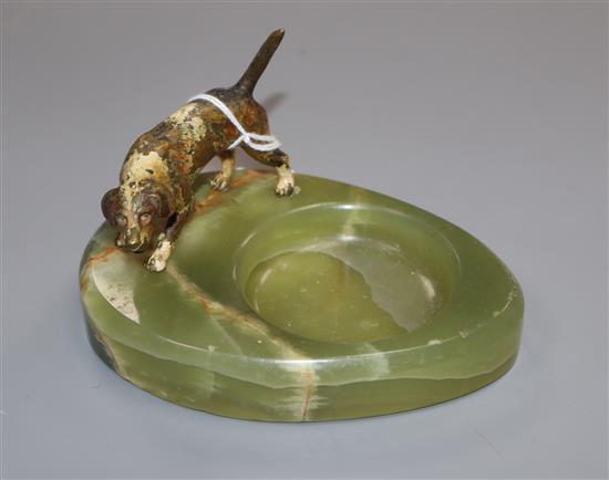 A cold plated bronze model of a dog and a green onyx ashtray